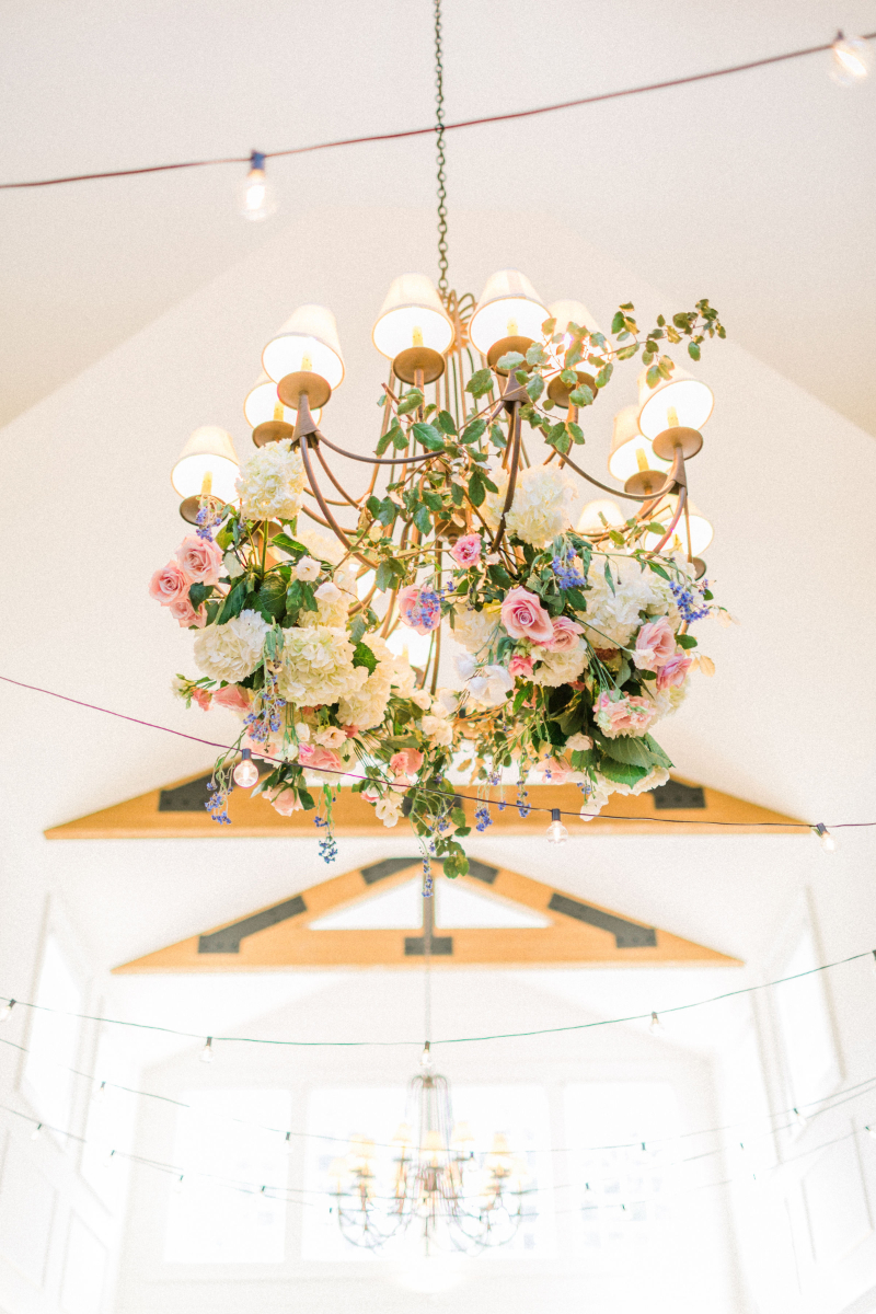 Floral hanging installment woven into chandelier. 