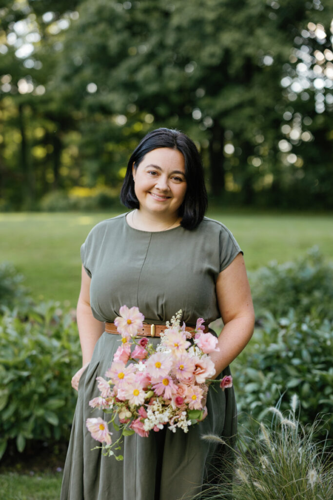 SOULFLORA owner stands with bouquet of seasonal New England flowers. 