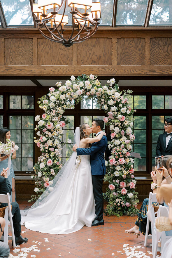 wedding ceremony floral arch with blush and white flowers and greenery