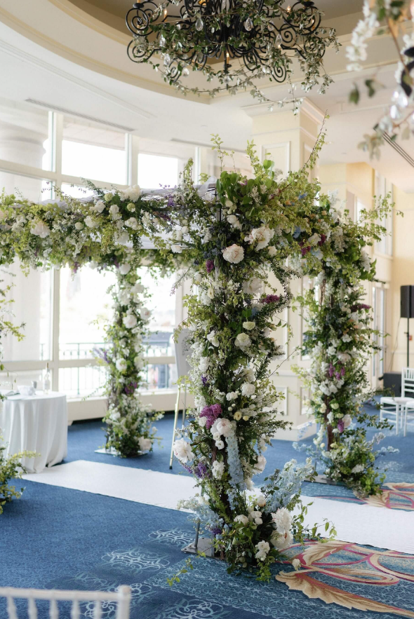 wedding ceremony floral arch with blush and white flowers and greenery