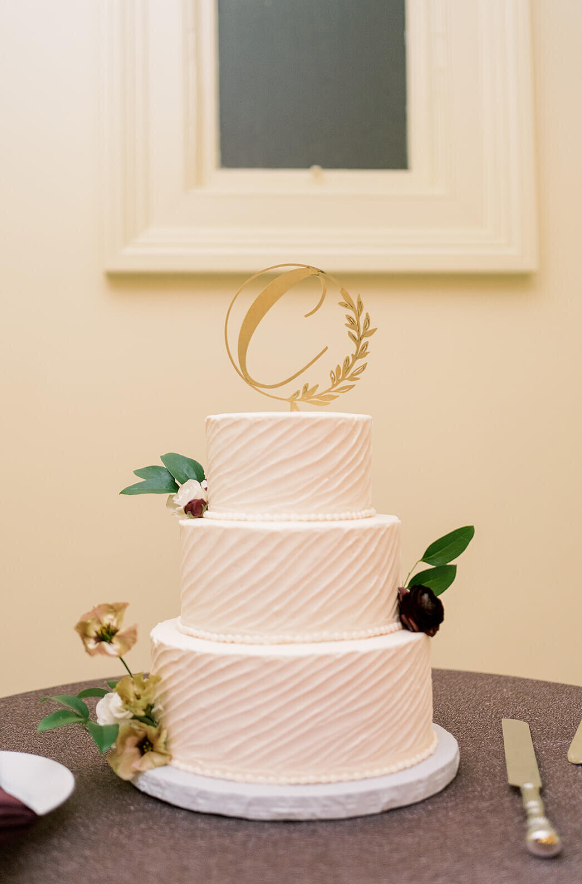 simple 3 tiered wedding cake with silver florals and leaf greenery in cake design