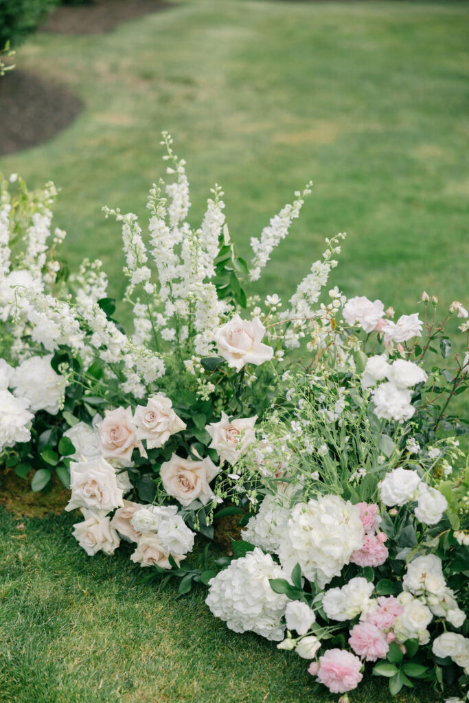 a white floral arrangement for a wedding ceremony