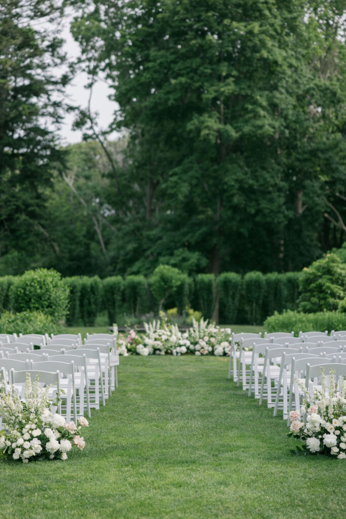 a white floral arrangement for a wedding ceremony