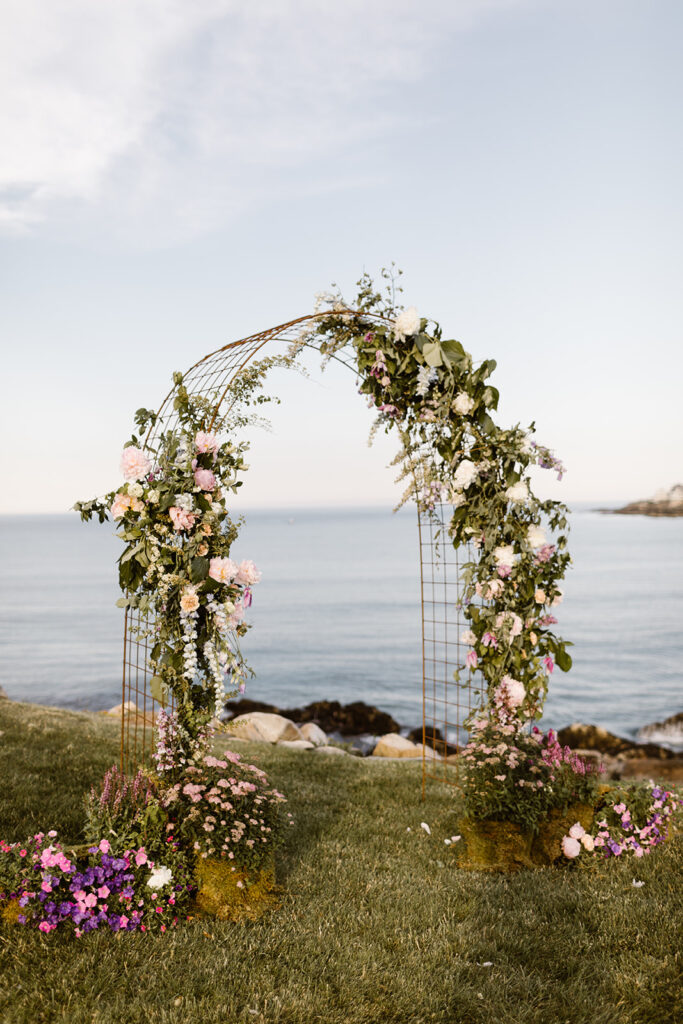 wedding ceremony arch with planted flowers at the base