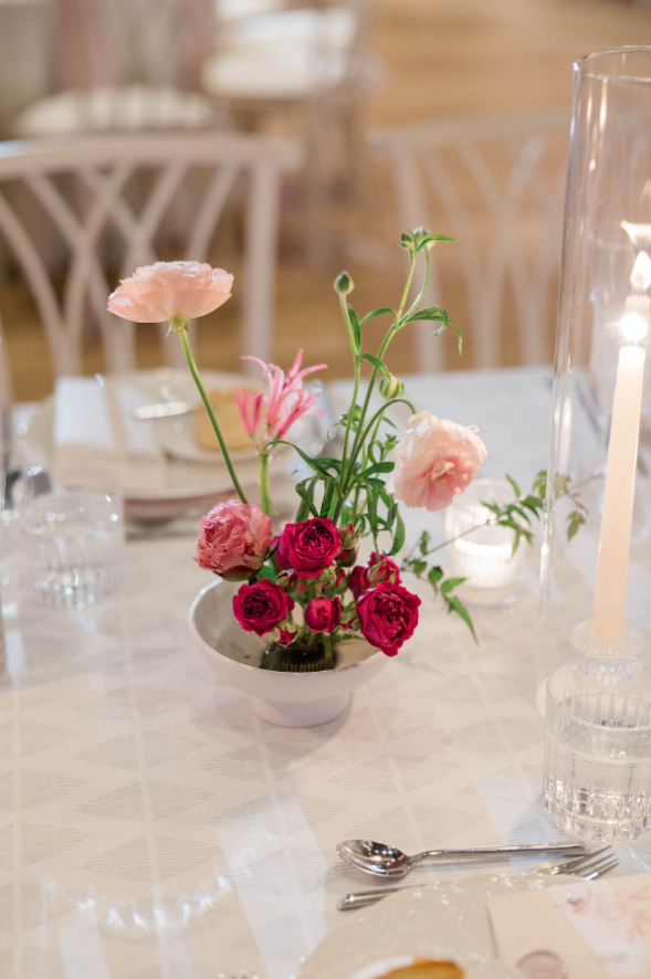 deep burgundy, and blush blooms in a pin frog arrangement 