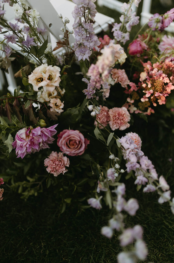 ceremony marker wedding florals of white, peach and purple blooms