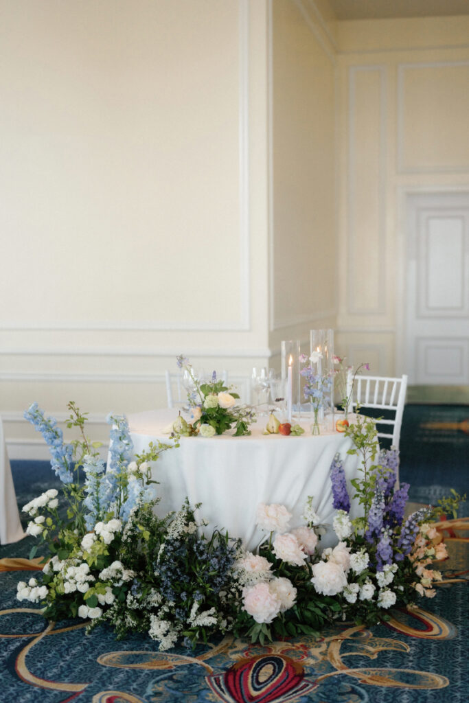 white blooms, delicate blue accents, and flowing greenery