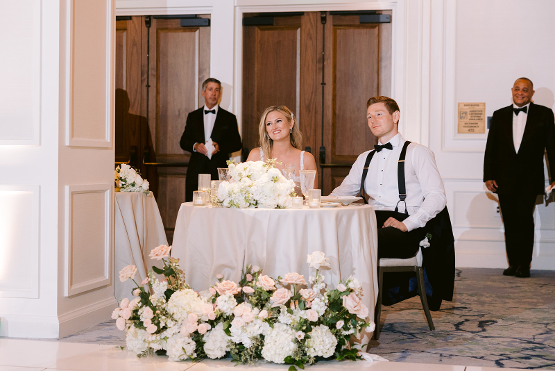 couple listening to speeches on their wedding day 