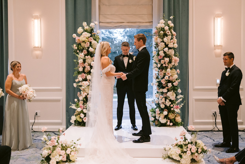 bride and groom with lovely floral altar at the Newbury Boston