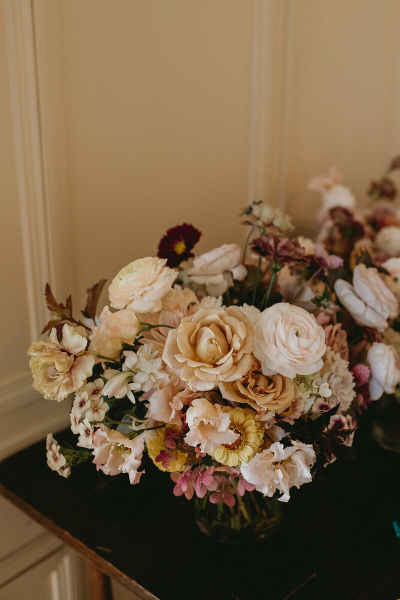 brides bouquet with warm champagne, gold, and peach to soft mauves and rose tones