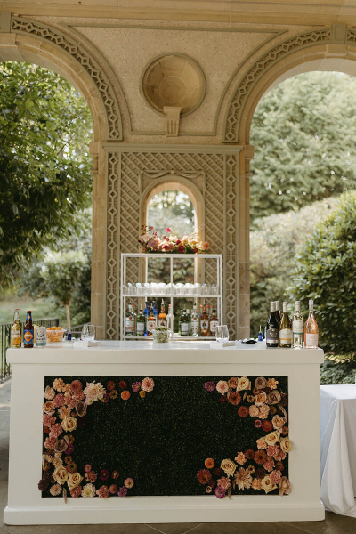 floral decorated bar at a wedding over-looking the garden at glen manor house 