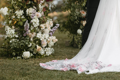 lush florals in the background of the bride's veil 