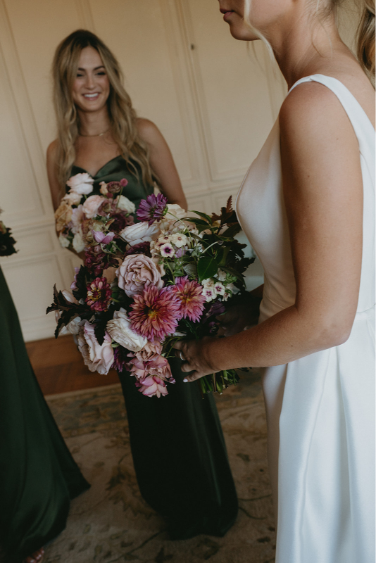 The bride's maid of honor admiring the bride before she walks down the isle 